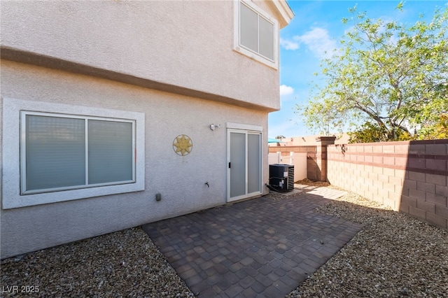 view of patio / terrace with fence and central air condition unit