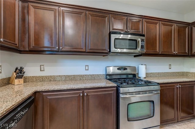9780 Ziegler Ave, Las Vegas, NV 89148 - kitchen featuring appliances with stainless steel finishes, dark brown cabinetry, and light stone countertops