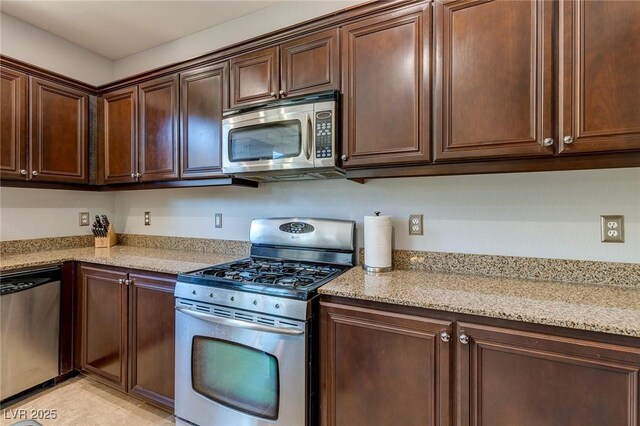 9780 Ziegler Ave, Las Vegas, NV 89148 - kitchen featuring stainless steel appliances, light stone countertops, and dark brown cabinetry