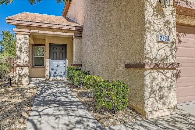 2728 Holmfault St, Henderson, NV 89044 - property entrance with stucco siding and a garage