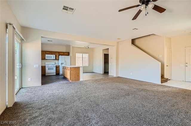 2728 Holmfault St, Henderson, NV 89044 - unfurnished living room with light colored carpet, stairs, and a ceiling fan