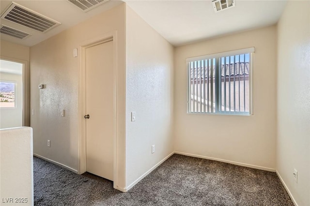 2728 Holmfault St, Henderson, NV 89044 - unfurnished bedroom featuring dark carpet, multiple windows, and baseboards
