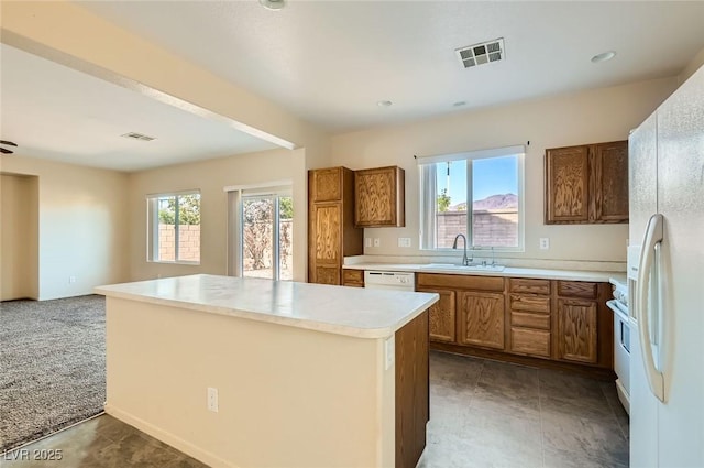 2728 Holmfault St, Henderson, NV 89044 - kitchen featuring a sink, white appliances, healthy amount of natural light, and brown cabinetry
