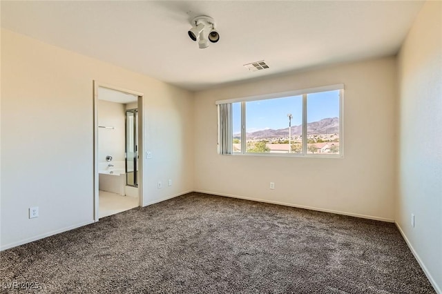 2728 Holmfault St, Henderson, NV 89044 - unfurnished bedroom featuring carpet flooring, a mountain view, baseboards, and ensuite bathroom