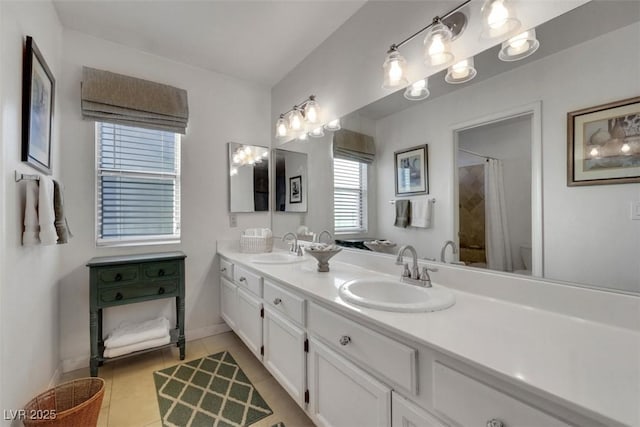 8388 Brad Oaks Cir, Las Vegas, NV 89123 - bathroom with baseboards, tile patterned floors, double vanity, curtained shower, and toilet