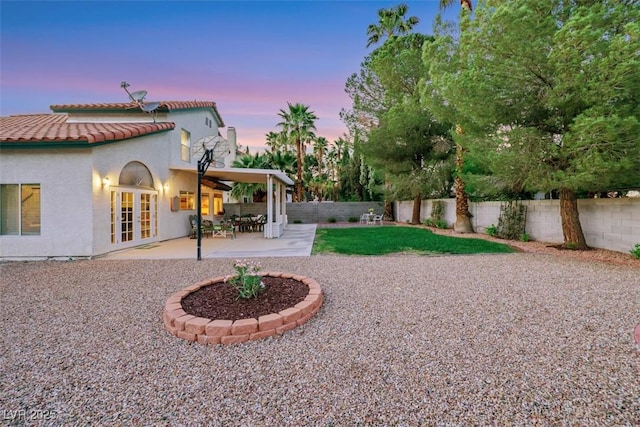 8388 Brad Oaks Cir, Las Vegas, NV 89123 - fenced backyard with french doors and a patio area