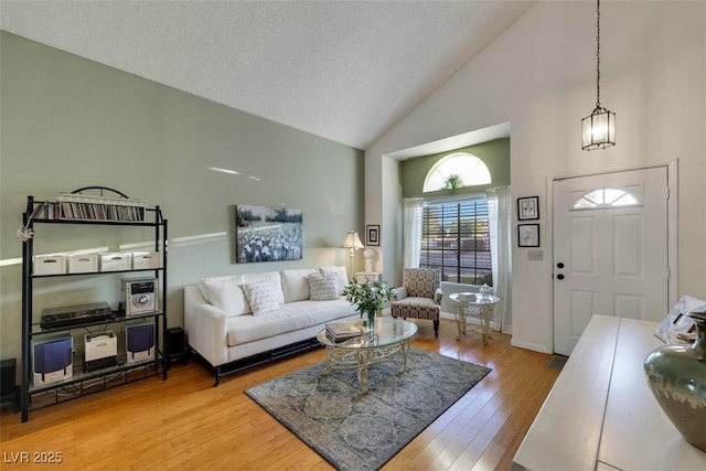 8388 Brad Oaks Cir, Las Vegas, NV 89123 - living area featuring high vaulted ceiling, wood finished floors, and a chandelier