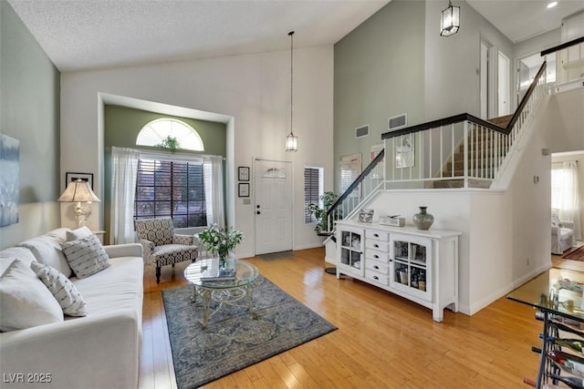 8388 Brad Oaks Cir, Las Vegas, NV 89123 - living room with stairs, high vaulted ceiling, and wood finished floors