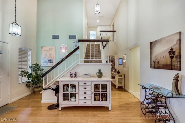 8388 Brad Oaks Cir, Las Vegas, NV 89123 - stairway with a towering ceiling, wood finished floors, and baseboards