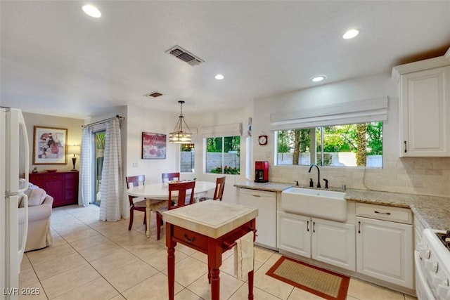 8388 Brad Oaks Cir, Las Vegas, NV 89123 - kitchen with white appliances, a sink, tasteful backsplash, recessed lighting, and light tile patterned floors