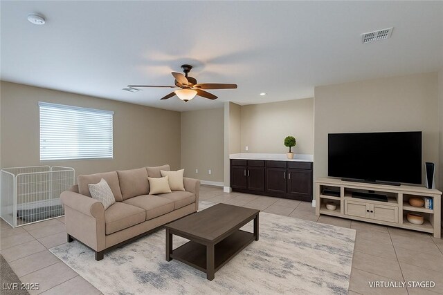 9469 Coral Shine Ct, Las Vegas, NV 89123 - living area with light tile patterned flooring, a ceiling fan, and baseboards