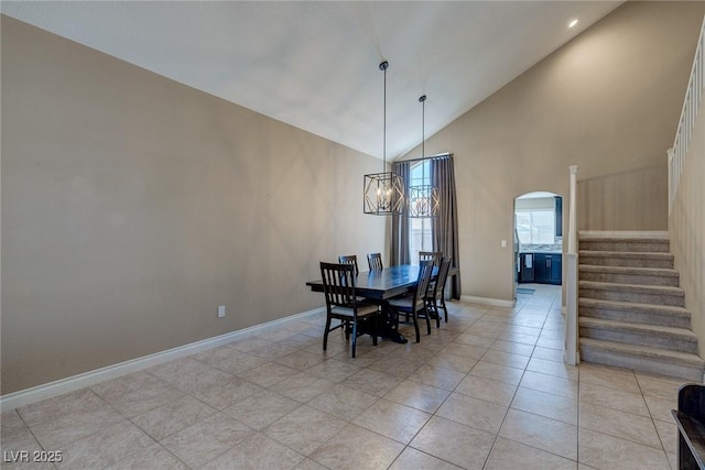 9469 Coral Shine Ct, Las Vegas, NV 89123 - dining area with stairway, arched walkways, baseboards, light tile patterned floors, and a chandelier