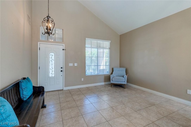 9469 Coral Shine Ct, Las Vegas, NV 89123 - foyer entrance with a chandelier, high vaulted ceiling, light tile patterned floors, and baseboards