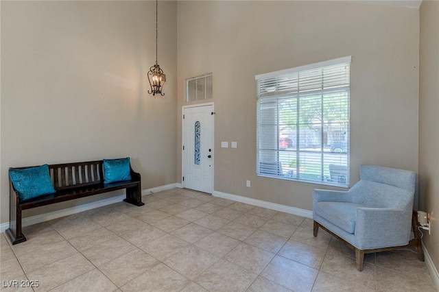 9469 Coral Shine Ct, Las Vegas, NV 89123 - entrance foyer with baseboards, a high ceiling, light tile patterned floors, and a chandelier