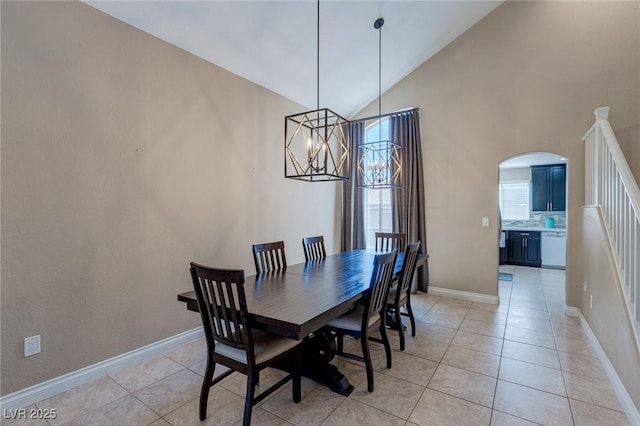 9469 Coral Shine Ct, Las Vegas, NV 89123 - dining space with arched walkways, light tile patterned floors, plenty of natural light, and high vaulted ceiling