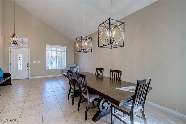 9469 Coral Shine Ct, Las Vegas, NV 89123 - dining space featuring a chandelier, high vaulted ceiling, baseboards, and light tile patterned floors