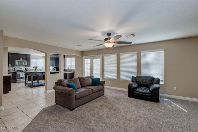9469 Coral Shine Ct, Las Vegas, NV 89123 - living area featuring arched walkways, ceiling fan, healthy amount of natural light, and baseboards