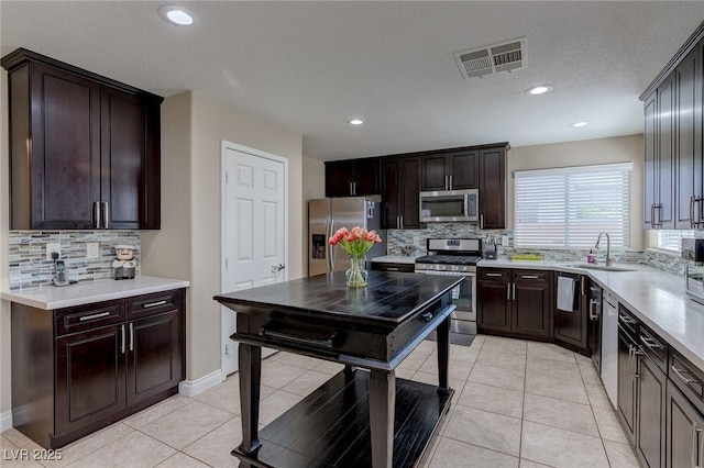 9469 Coral Shine Ct, Las Vegas, NV 89123 - kitchen featuring appliances with stainless steel finishes, a sink, tasteful backsplash, light countertops, and recessed lighting