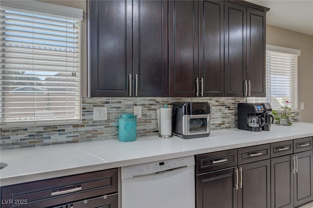 9469 Coral Shine Ct, Las Vegas, NV 89123 - kitchen featuring dishwasher, backsplash, light countertops, and dark brown cabinetry