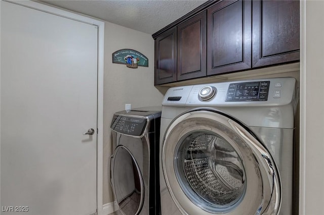 9469 Coral Shine Ct, Las Vegas, NV 89123 - laundry room with cabinet space, washer and clothes dryer, and a textured ceiling