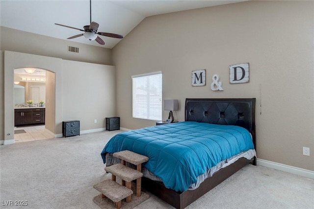 9469 Coral Shine Ct, Las Vegas, NV 89123 - bedroom featuring light colored carpet, arched walkways, baseboards, high vaulted ceiling, and connected bathroom