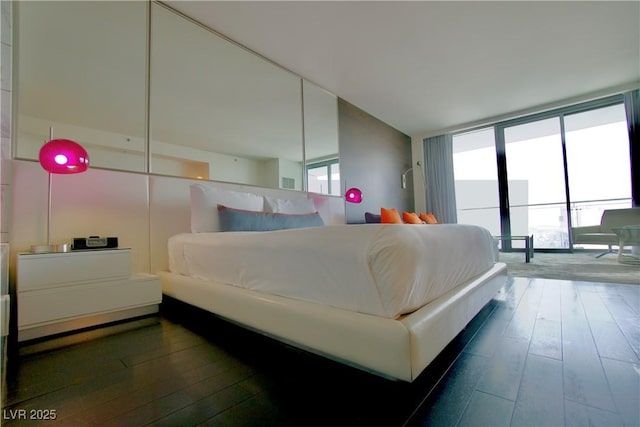 bedroom with dark wood-style flooring
