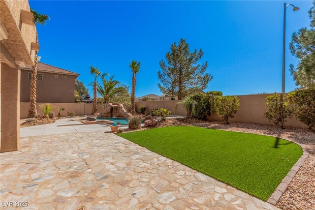 8809 Barium Rock Ave, Las Vegas, NV 89143 - fenced backyard with a patio area