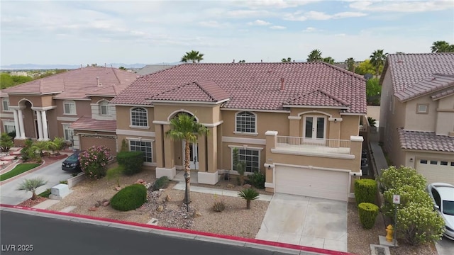 8809 Barium Rock Ave, Las Vegas, NV 89143 - mediterranean / spanish-style home with french doors, stucco siding, concrete driveway, a tile roof, and an attached garage