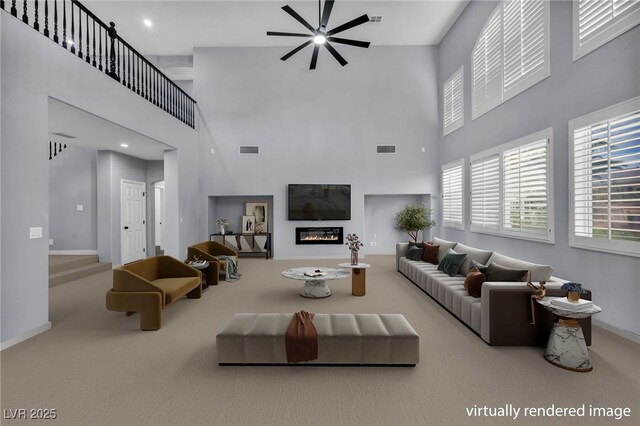 8809 Barium Rock Ave, Las Vegas, NV 89143 - carpeted living area with a ceiling fan, a towering ceiling, a glass covered fireplace, and recessed lighting