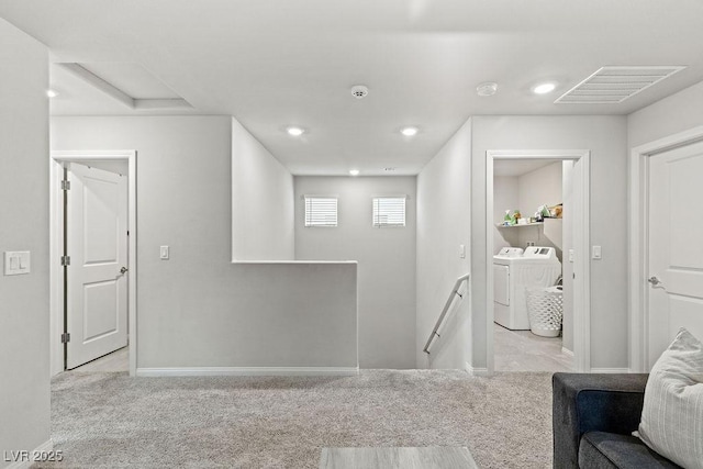 interior space with an upstairs landing, washing machine and clothes dryer, carpet floors, baseboards, and recessed lighting