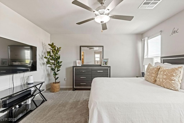 carpeted bedroom with a ceiling fan and baseboards
