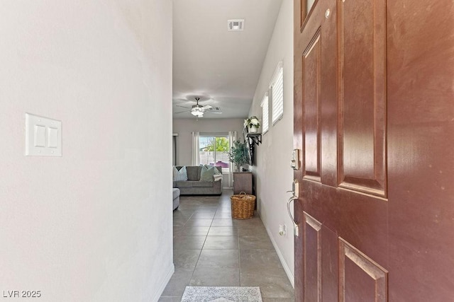 hall with baseboards and light tile patterned flooring