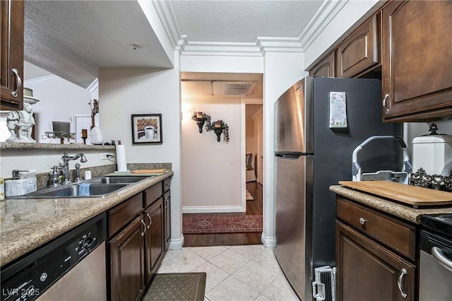 8101 W Flamingo Rd Unit 2006, Las Vegas, NV 89147 - kitchen featuring appliances with stainless steel finishes, a sink, crown molding, dark brown cabinets, and a textured ceiling