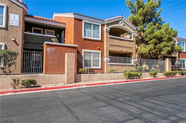 8101 W Flamingo Rd Unit 2006, Las Vegas, NV 89147 - townhome / multi-family property featuring stucco siding, a tile roof, and fence