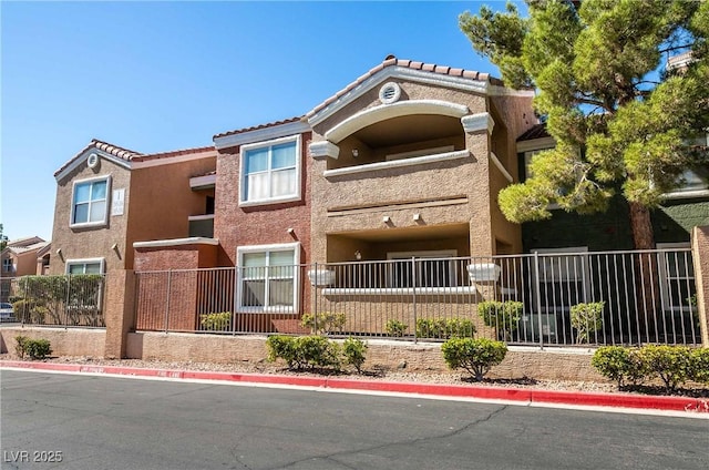 8101 W Flamingo Rd Unit 2006, Las Vegas, NV 89147 - view of front of property with fence, stucco siding, and a tile roof