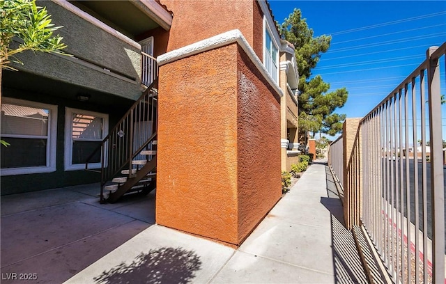 8101 W Flamingo Rd Unit 2006, Las Vegas, NV 89147 - view of property exterior featuring stucco siding, stairs, and a patio