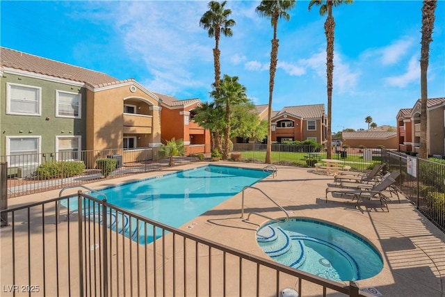 8101 W Flamingo Rd Unit 2006, Las Vegas, NV 89147 - community pool featuring a hot tub, a patio, fence, and a residential view