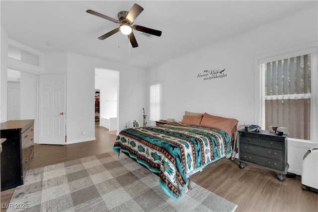 1893 Donnington Ct, Las Vegas, NV 89123 - bedroom with wood finished floors, ceiling fan, a walk in closet, and baseboards