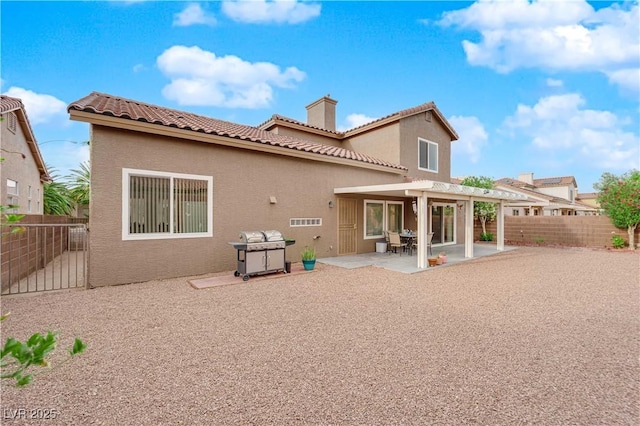 1893 Donnington Ct, Las Vegas, NV 89123 - rear view of house with a chimney, a fenced backyard, stucco siding, a pergola, and a tile roof