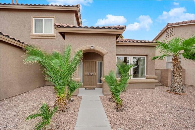 1893 Donnington Ct, Las Vegas, NV 89123 - property entrance with a tiled roof and stucco siding