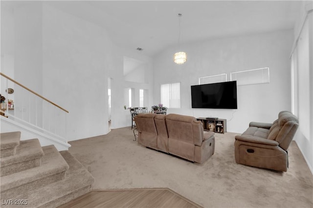 1893 Donnington Ct, Las Vegas, NV 89123 - carpeted living room featuring stairs and high vaulted ceiling