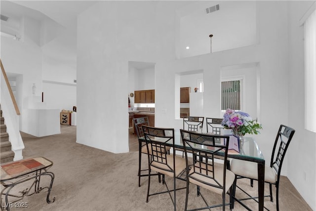 1893 Donnington Ct, Las Vegas, NV 89123 - dining space with a towering ceiling, carpet flooring, stairs, and baseboards