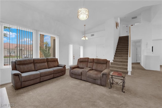 1893 Donnington Ct, Las Vegas, NV 89123 - carpeted living area with a high ceiling, stairs, a chandelier, and baseboards