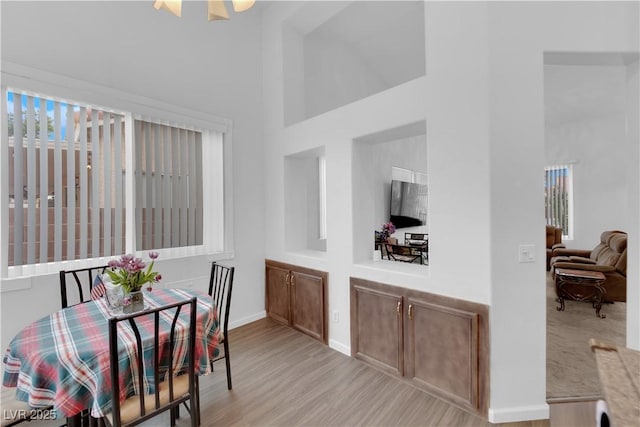 1893 Donnington Ct, Las Vegas, NV 89123 - dining space featuring a high ceiling, light wood-type flooring, and baseboards