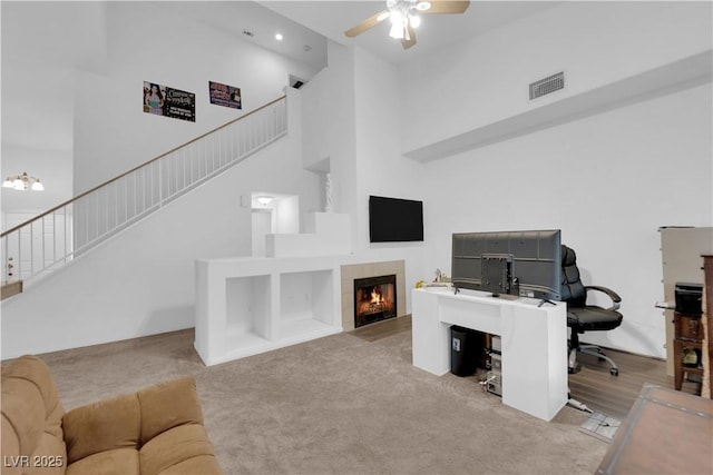 1893 Donnington Ct, Las Vegas, NV 89123 - office space with a high ceiling, a ceiling fan, light carpet, and a fireplace
