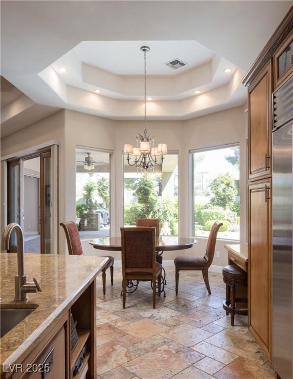 8620 W La Madre Way, Las Vegas, NV 89149 - dining area with a tray ceiling, plenty of natural light, stone tile flooring, a chandelier, and recessed lighting