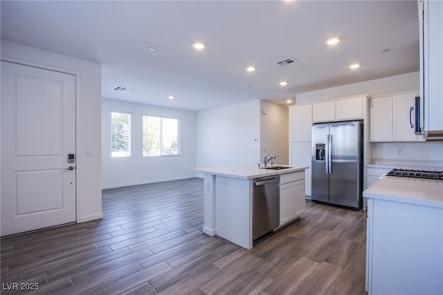 145 Aqua Commons Ln, Henderson, NV 89015 - kitchen with stainless steel appliances, a sink, light countertops, a center island with sink, and white cabinetry