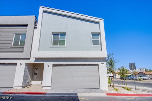 145 Aqua Commons Ln, Henderson, NV 89015 - view of front of home featuring a garage and stucco siding