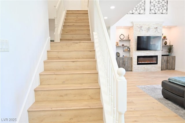 10591 Haywood Dr, Las Vegas, NV 89135 - stairs with wood finished floors and a glass covered fireplace