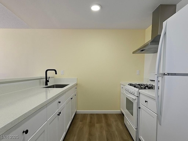 kitchen with white appliances, a sink, dark wood-style flooring, light countertops, and baseboards